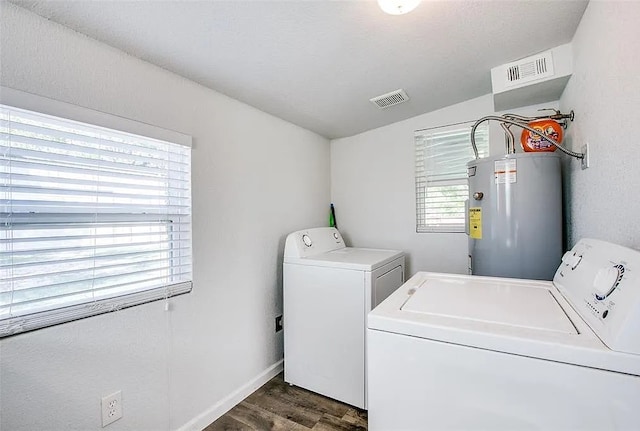 laundry area featuring washer and dryer, electric water heater, visible vents, and laundry area