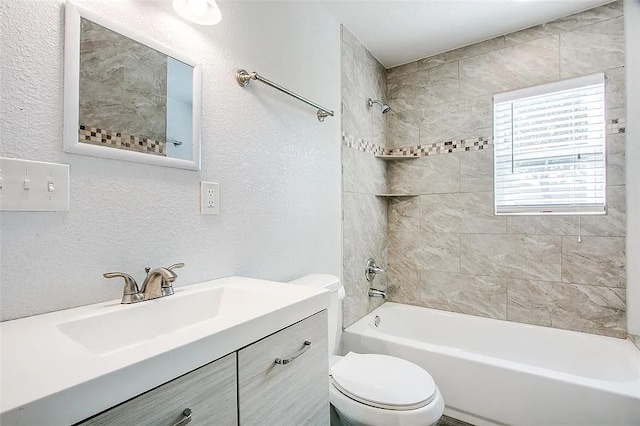 full bath with vanity, a textured wall, toilet, and tub / shower combination