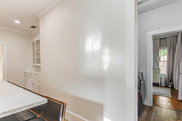 4621 Pershing Ave, Fort Worth, TX 76107 - hall featuring recessed lighting, wood finished floors, ornamental molding, washing machine and dryer, and visible vents