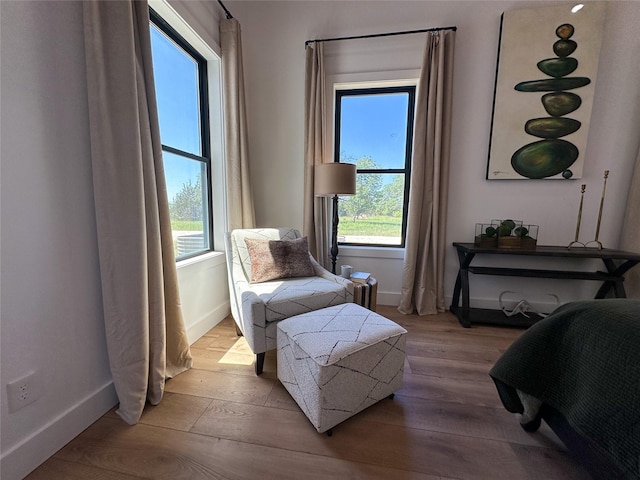 sitting room with wood finished floors and baseboards
