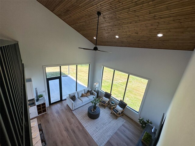 living room with wooden ceiling, recessed lighting, wood finished floors, and high vaulted ceiling