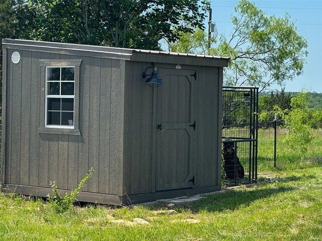 view of shed featuring fence