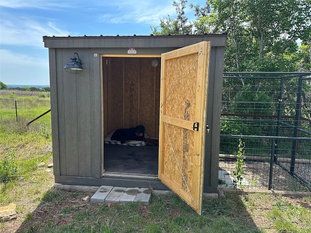 view of shed with fence