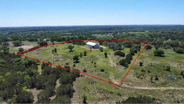drone / aerial view featuring a rural view and a forest view