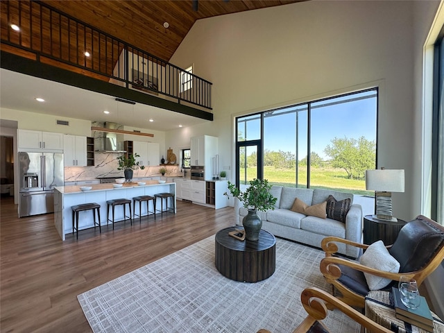 living room with dark wood-style floors, recessed lighting, high vaulted ceiling, visible vents, and wood ceiling