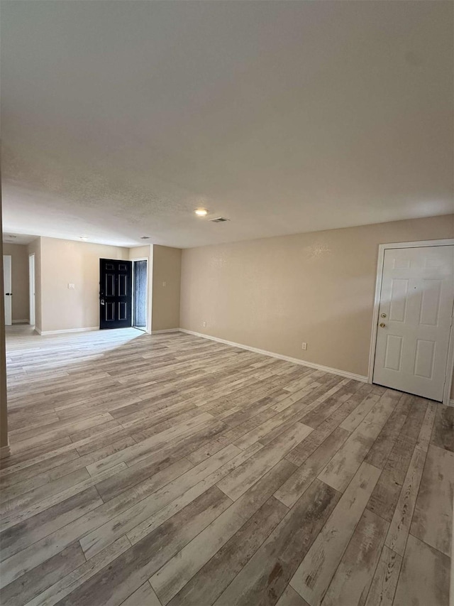 2726 Kellogg Ave, Dallas, TX 75216 - unfurnished living room featuring light wood-style flooring and baseboards