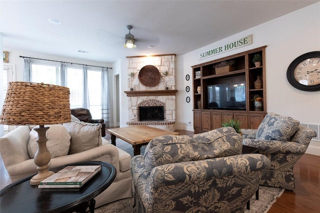 2621 Timberhollow Dr, Little Elm, TX 75068 - living area featuring visible vents, baseboards, a fireplace, wood finished floors, and a ceiling fan