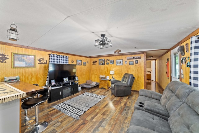 4991 Thunderbird Dr, May, TX 76857 - living area featuring a textured ceiling, wood walls, and wood finished floors