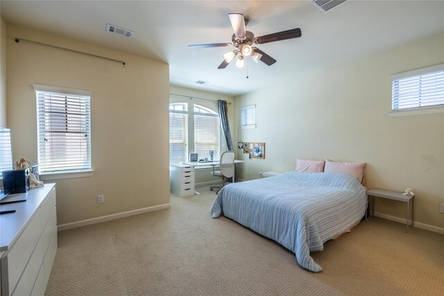 bedroom featuring visible vents, baseboards, and light carpet