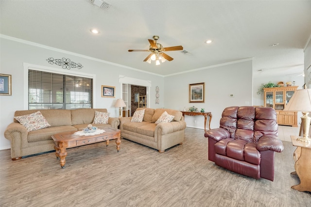living area featuring baseboards, a ceiling fan, wood finished floors, and visible vents