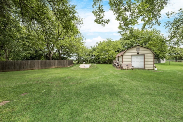 view of yard featuring fence and an outdoor structure