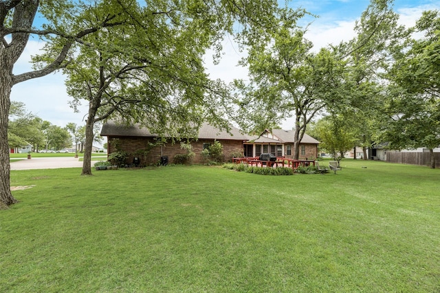 1219 Kiowa Dr E, Gainesville, TX 76240 - view of yard featuring fence and an outdoor structure