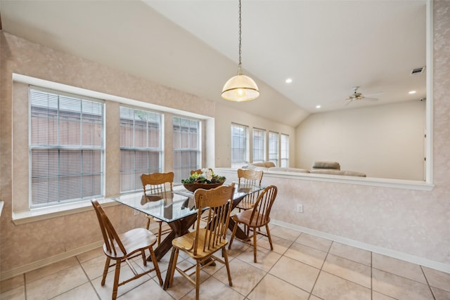dining space featuring baseboards, light tile patterned floors, lofted ceiling, and ceiling fan