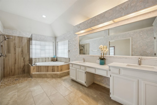 full bathroom with double vanity, a sink, a garden tub, and tiled shower