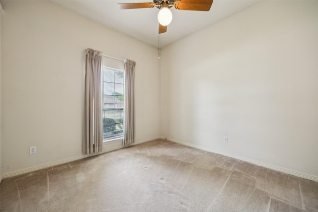 carpeted empty room with baseboards and a ceiling fan