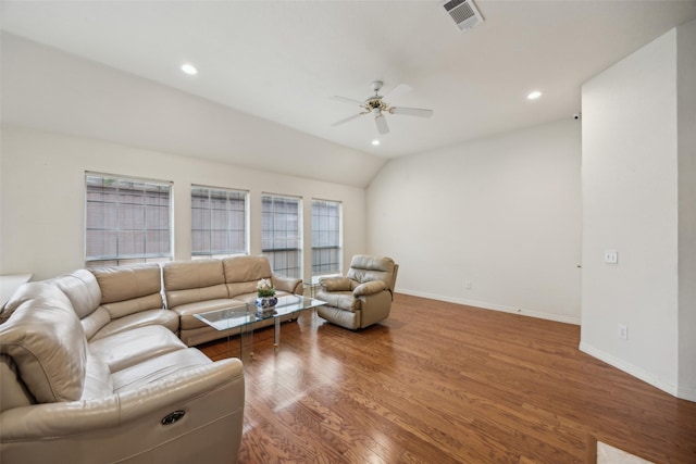living room featuring visible vents, wood finished floors, baseboards, ceiling fan, and vaulted ceiling