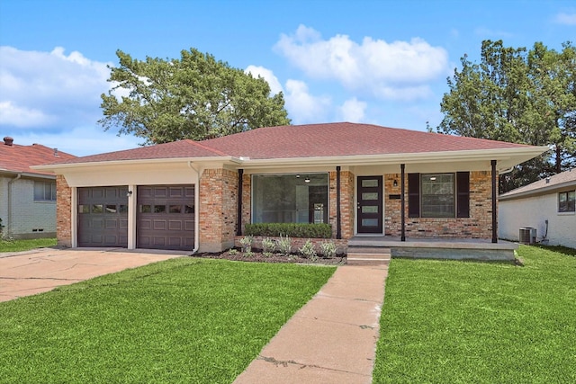 single story home featuring driveway, a porch, a front lawn, and a garage