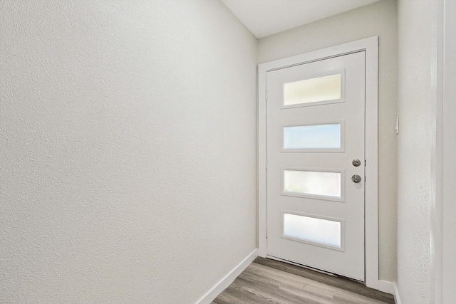 entryway featuring light wood-style floors and baseboards
