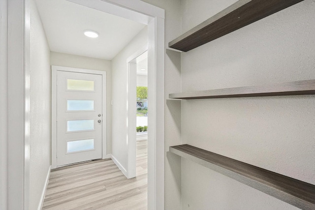 entryway with baseboards and light wood-type flooring