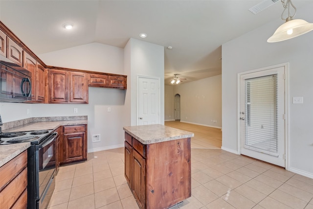 kitchen featuring light tile patterned floors, black appliances, ceiling fan, and a kitchen island