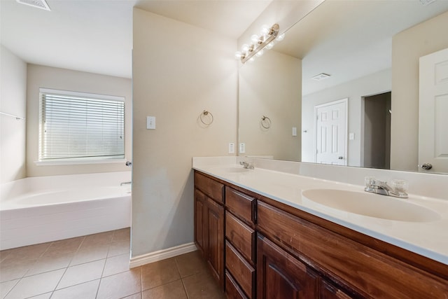 bathroom with tile patterned flooring, double vanity, a sink, visible vents, and a garden tub