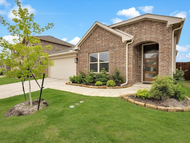 view of front of house with a front yard, a garage, brick siding, concrete driveway, and fence