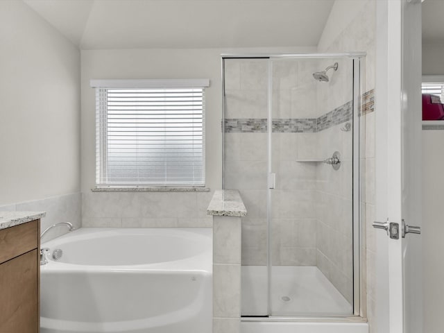 full bath featuring a garden tub, a shower stall, and vanity