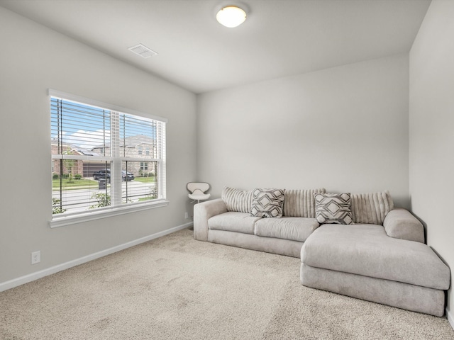 living area featuring carpet, visible vents, and baseboards