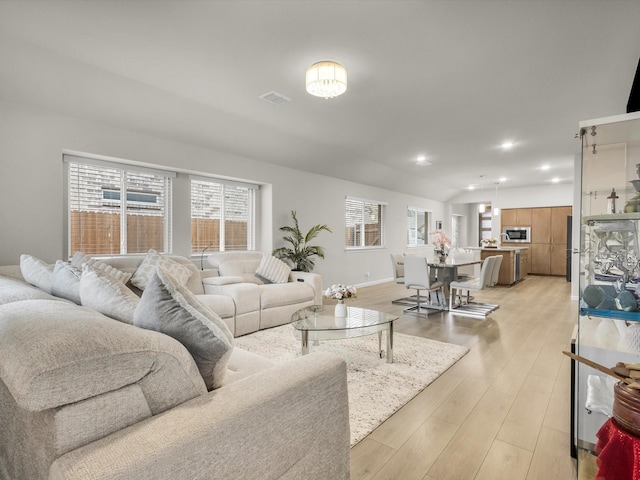 living room with visible vents, recessed lighting, baseboards, and light wood-style floors
