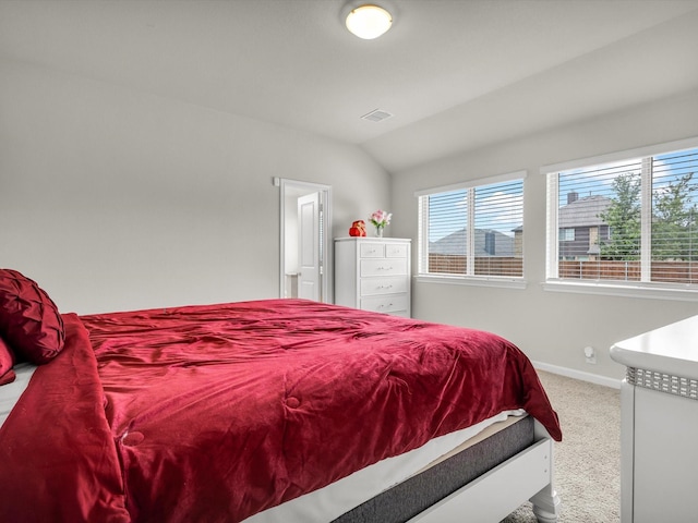 carpeted bedroom featuring baseboards, visible vents, and lofted ceiling
