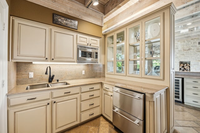 403 Hilltop, Trophy Club, TX 76262 - kitchen with cream cabinets, decorative backsplash, appliances with stainless steel finishes, a sink, and stone tile floors