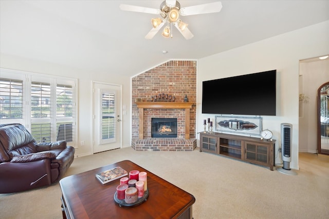living room with carpet floors, ceiling fan, a brick fireplace, baseboards, and lofted ceiling
