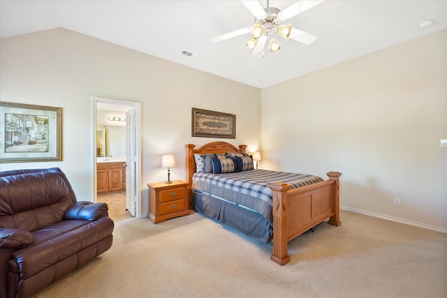bedroom featuring ensuite bath, visible vents, vaulted ceiling, light carpet, and baseboards