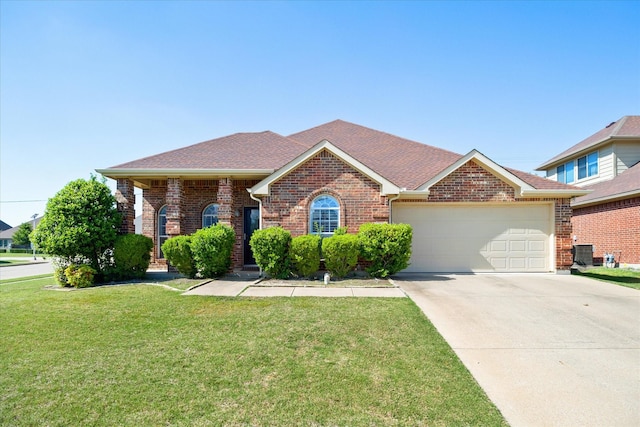 ranch-style house featuring concrete driveway, a shingled roof, a front yard, brick siding, and a garage