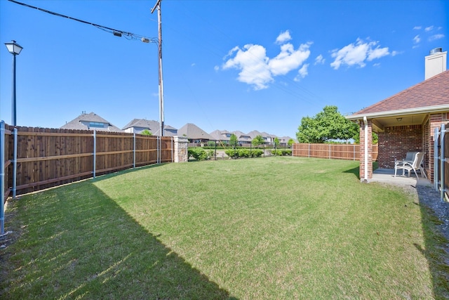 view of yard with a residential view and a fenced backyard