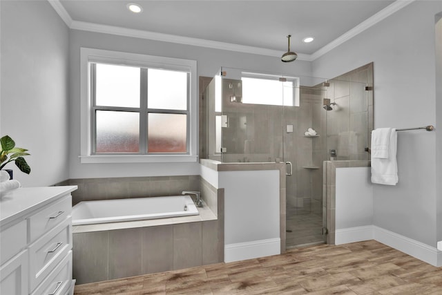 full bathroom featuring crown molding, vanity, a shower stall, and a garden tub