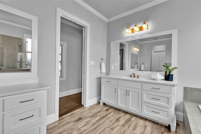 bathroom featuring crown molding, vanity, wood finished floors, baseboards, and walk in shower