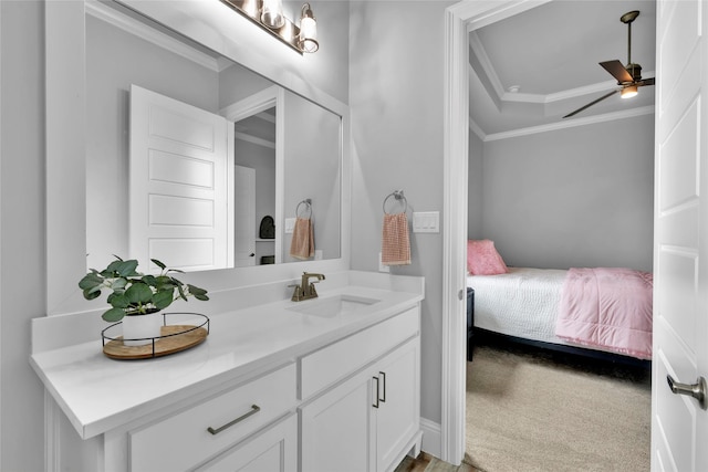 ensuite bathroom with vanity, ornamental molding, ensuite bath, and ceiling fan