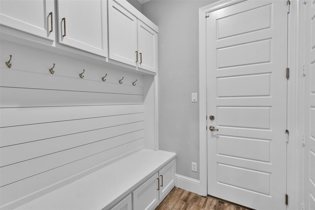 mudroom featuring baseboards and wood finished floors