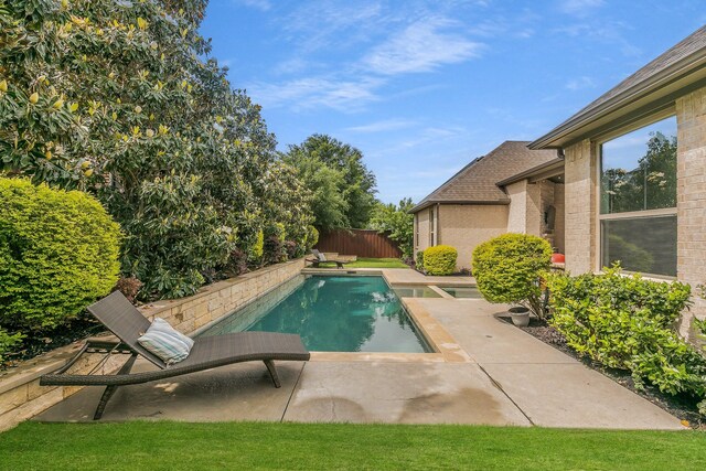 view of swimming pool with a fenced in pool, a patio area, and fence