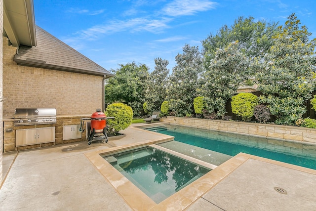 outdoor pool featuring an outdoor kitchen, an in ground hot tub, a patio, and a grill
