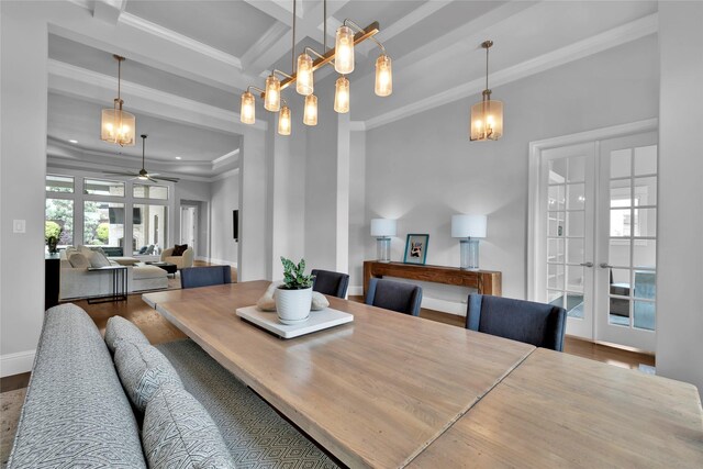 dining area featuring ornamental molding, wood finished floors, beamed ceiling, french doors, and a ceiling fan