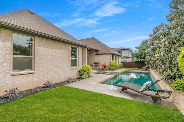 view of swimming pool featuring a yard, a patio, a fenced in pool, and a fenced backyard