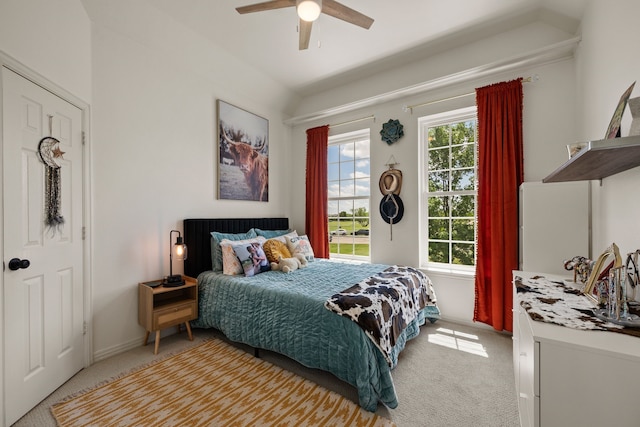bedroom featuring baseboards, a ceiling fan, light colored carpet, and vaulted ceiling