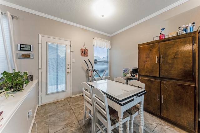 dining room with ornamental molding and baseboards