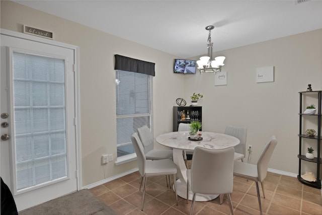 5652 Giddyup Ln, Fort Worth, TX 76179 - tiled dining area featuring a chandelier and baseboards