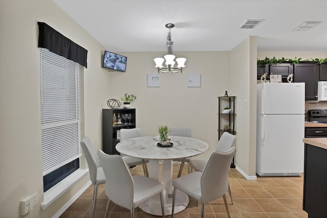 5652 Giddyup Ln, Fort Worth, TX 76179 - dining space featuring an inviting chandelier, light tile patterned flooring, visible vents, and baseboards
