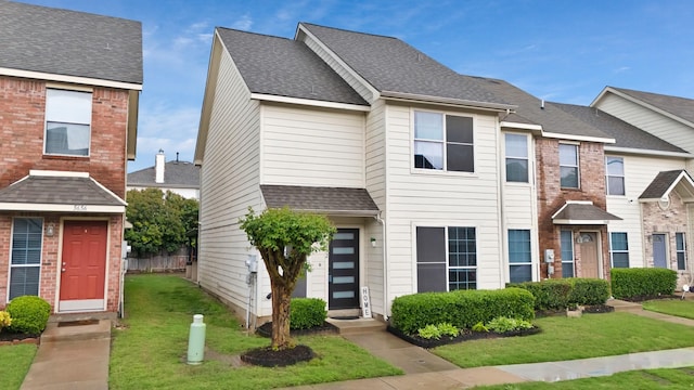 5652 Giddyup Ln, Fort Worth, TX 76179 - townhome / multi-family property with a shingled roof, entry steps, and a front lawn