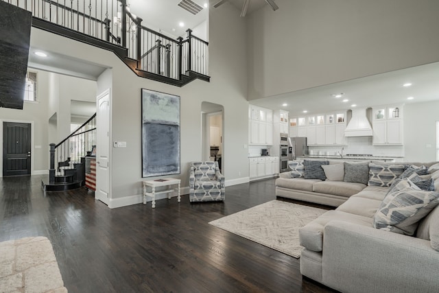 505 Eloise Dr, Heath, TX 75032 - living area featuring visible vents, ceiling fan, dark wood-style flooring, a high ceiling, and stairs