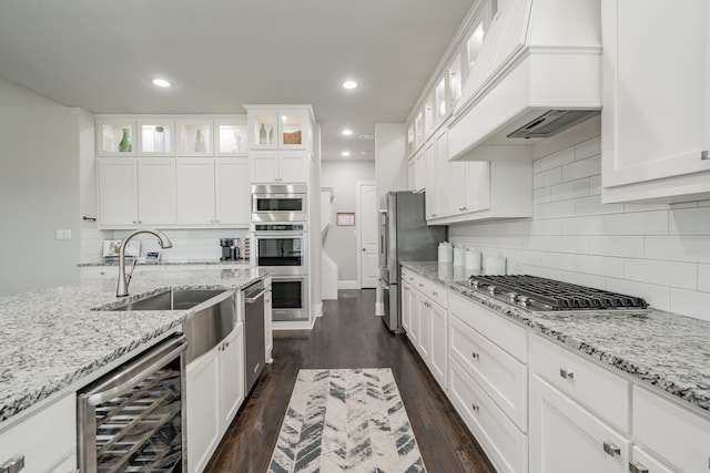 505 Eloise Dr, Heath, TX 75032 - kitchen featuring a sink, decorative backsplash, wine cooler, custom range hood, and appliances with stainless steel finishes